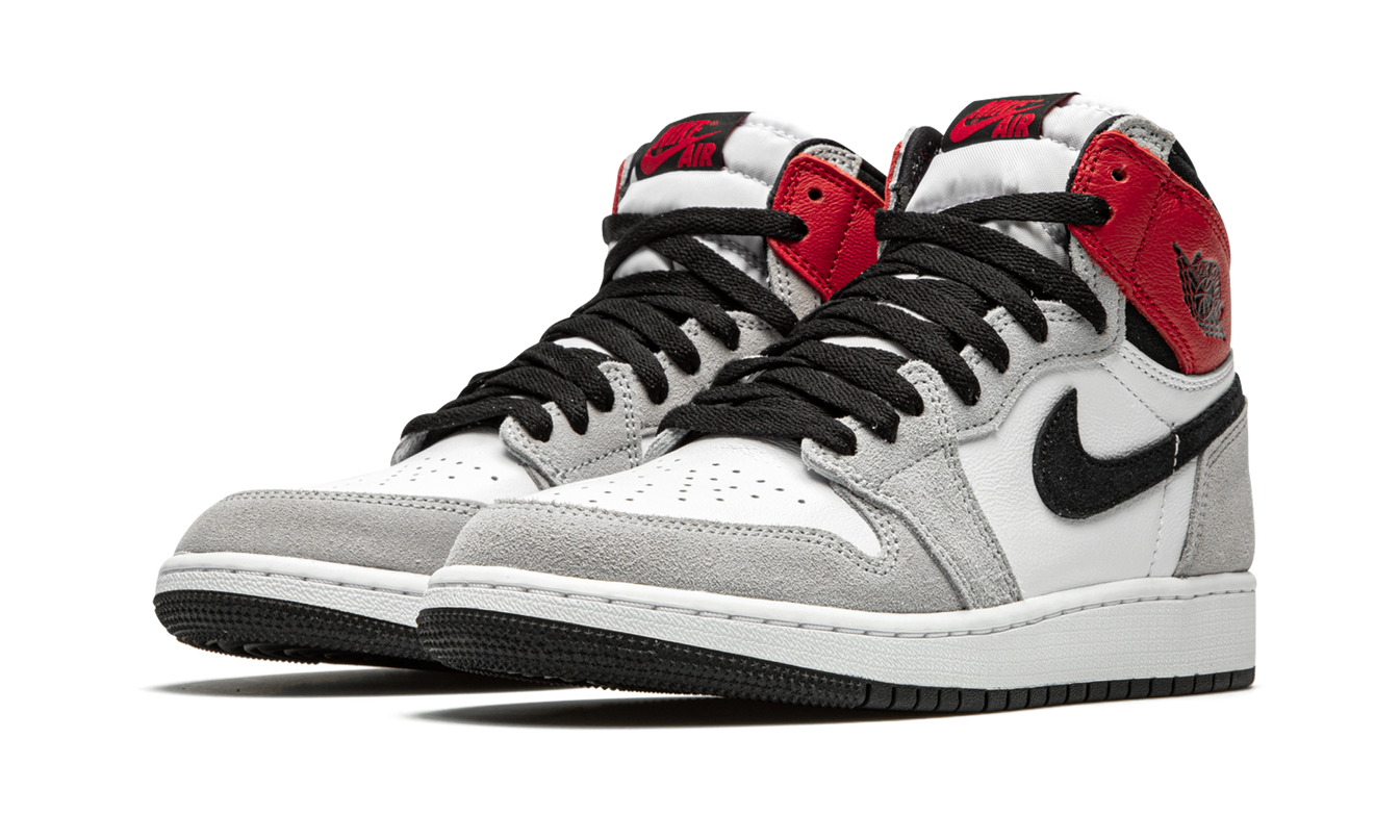 Lichte grijze Air Jordan 1 Retro High OG GS sneakers met zwart en wit details, zichtbaar in de afbeelding.
