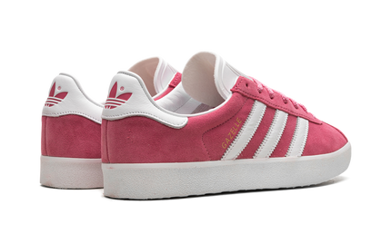Roze Adidas Gazelle 85 schoenen met witte zool en zijstreep, stijlvolle sneakers voor dames en heren.