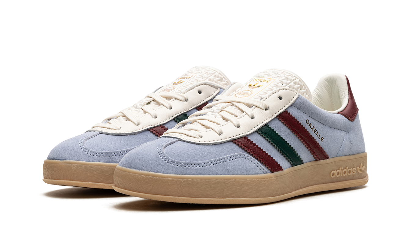 Blauwe Adidas Gazelle indoor schoenen met witte details en blauwe veters, geschikt voor binnen sporten.