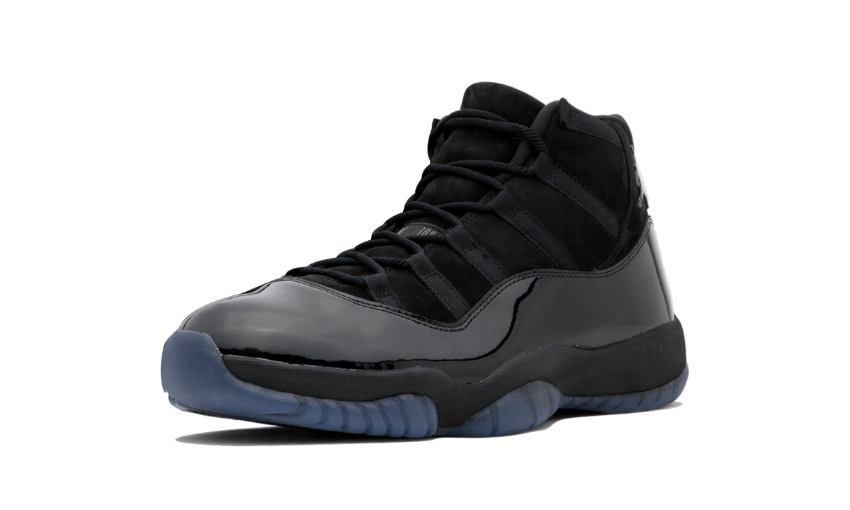 Zwarte Air Jordan 11 Retro "Cap & Gown" sneakers met glanzende afwerking en witte details op de zool, gedragen door een model.