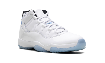 Witte en blauwe Air Jordan 11 Retro sneakers met glanzende afwerking en zwarte details, gedragen door een model.