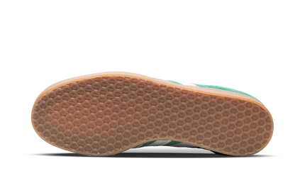 Groene Adidas Gazelle schoenen met gumzool, zwart en groen ontwerp, zichtbaar van de zijkant.