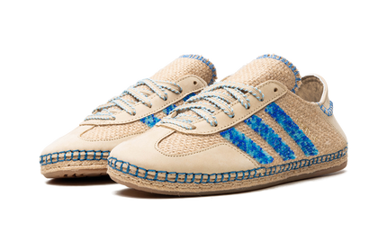 Adidas Gazelle schoenen van CLOT in linnen khaki en lichtblauw, tonen het zijprofiel met merklogo en geklede details.