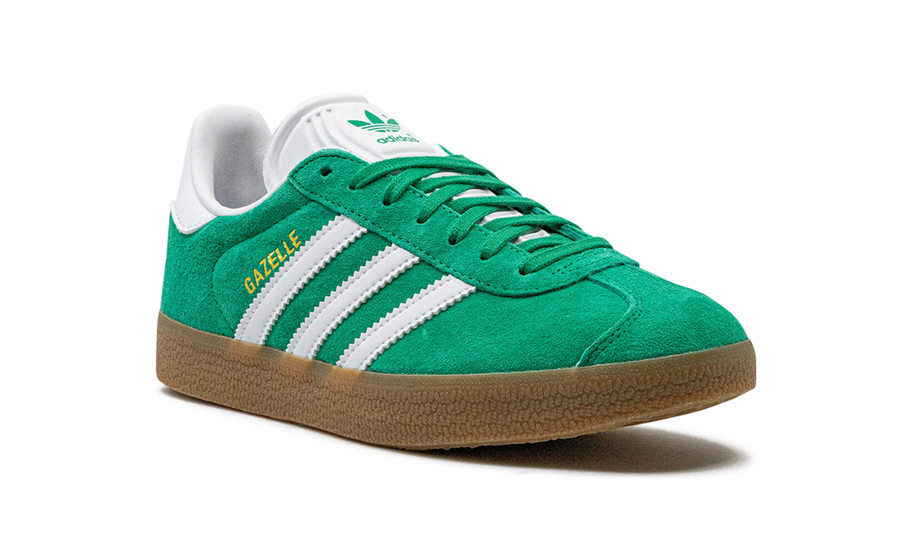 Groene Adidas Gazelle schoenen voor dames met witte zool en leren bovenkant, casual en sportief ontwerp.