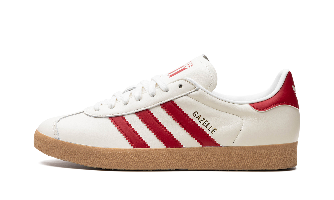 Dames Adidas Gazelle Peru sneakers in beige en zwart met leren bovenwerk en witte zool op een witte achtergrond